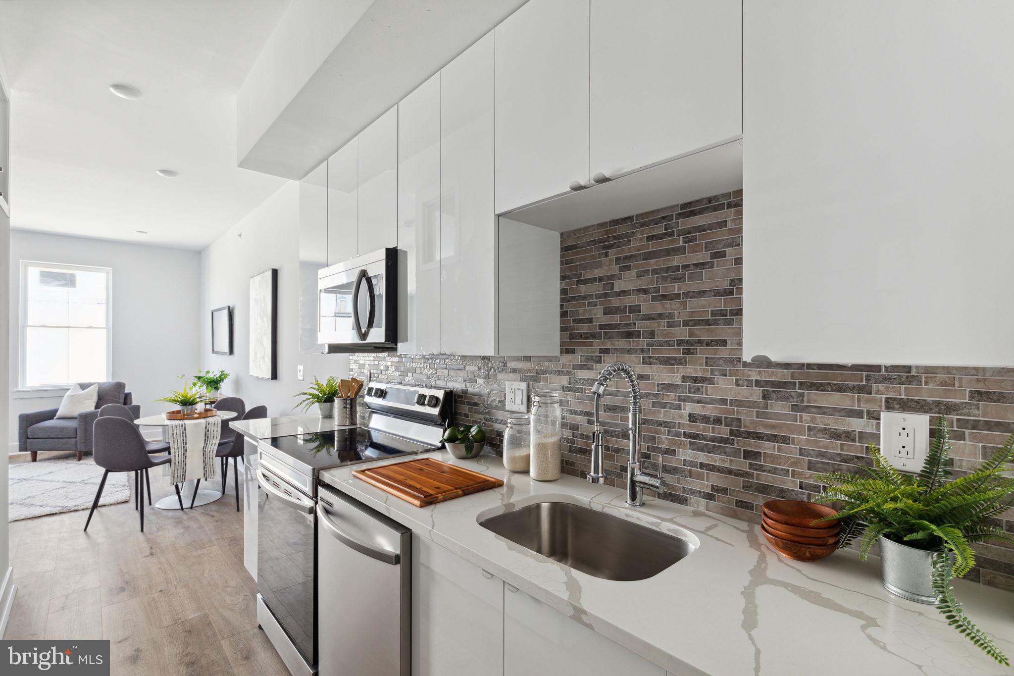 1439 Federal Street, Unit 211 Philadelphia, PA 19146 - Photo 8 of 21 a kitchen with a sink and cabinets