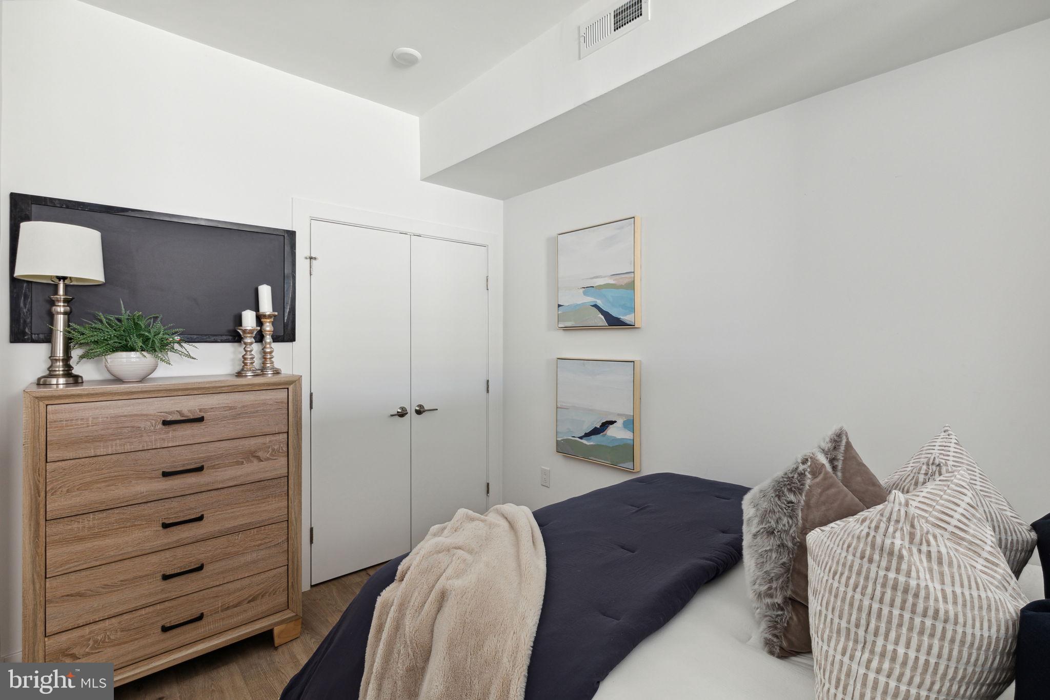 1439 Federal Street, Unit 211 Philadelphia, PA 19146 - Photo 9 of 21 a bedroom with a bed and a mirror