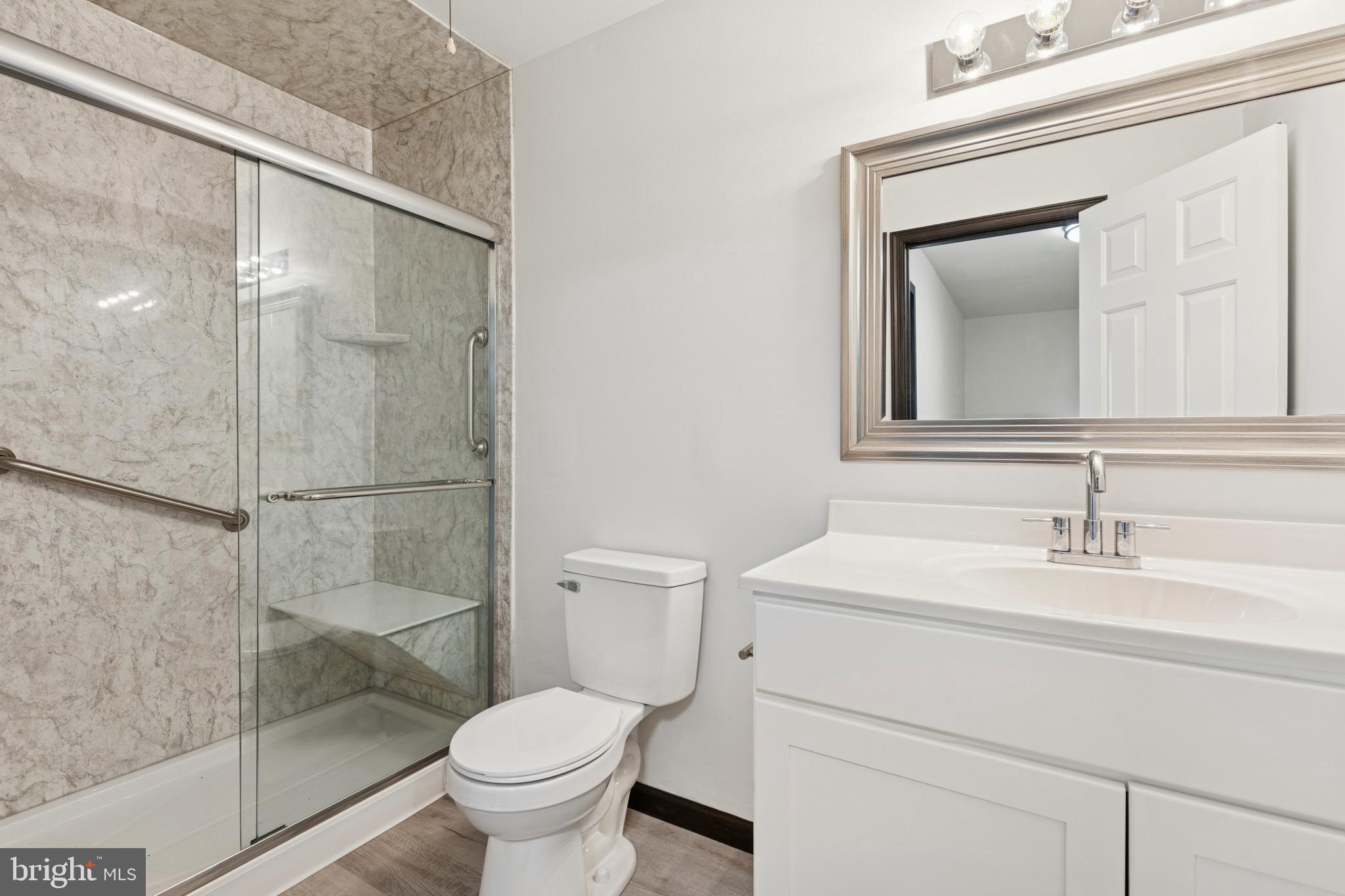615 Longwood Road Collegeville, PA 19426 - Photo 16 of 25 a bathroom with a toilet sink vanity and mirror