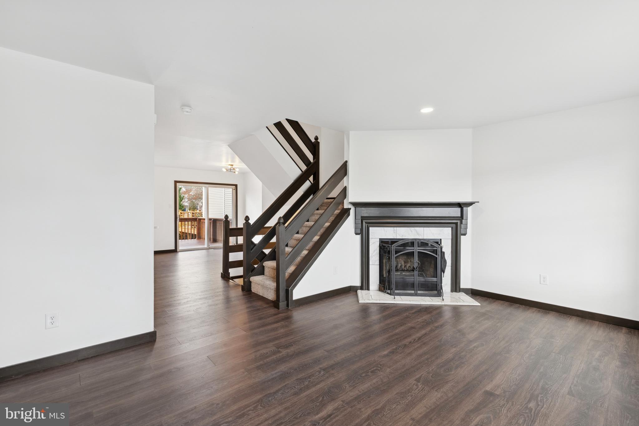 615 Longwood Road Collegeville, PA 19426 - Photo 4 of 25 a view of an empty room with wooden floor stairs