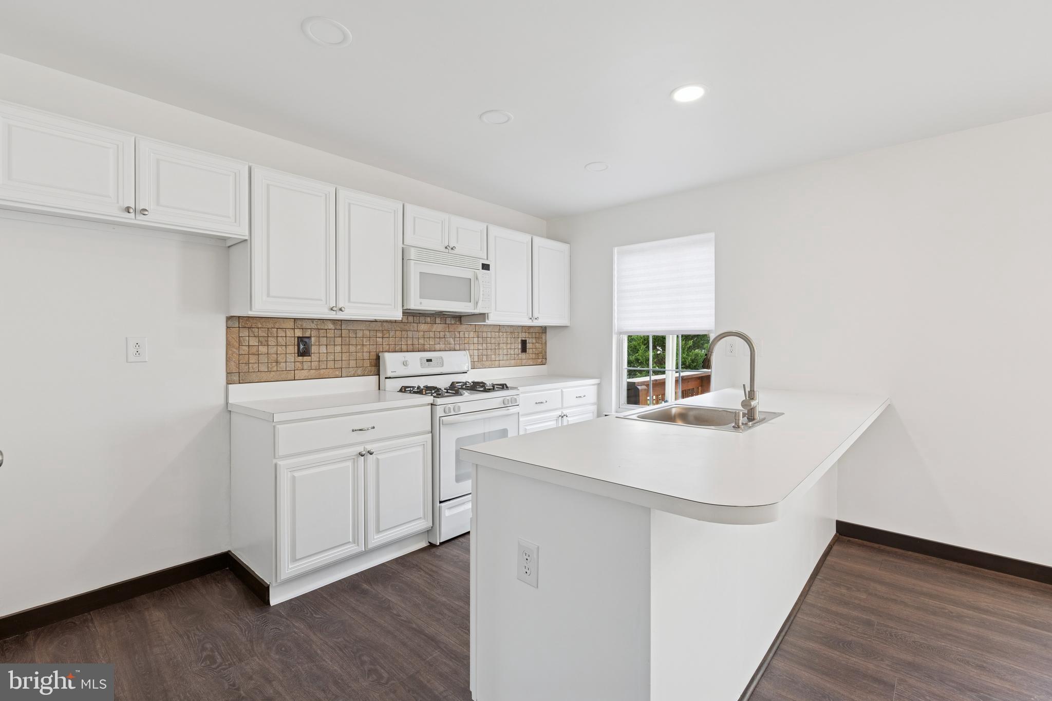 615 Longwood Road Collegeville, PA 19426 - Photo 7 of 25 a kitchen with appliances a sink and a stove top oven