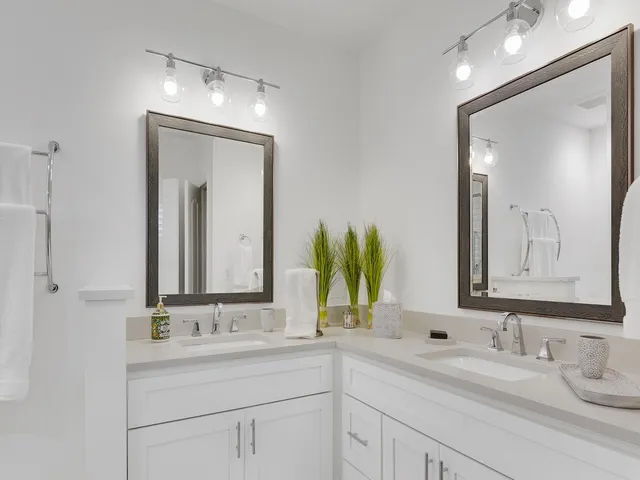 a bathroom with double vanity sinks and a mirror