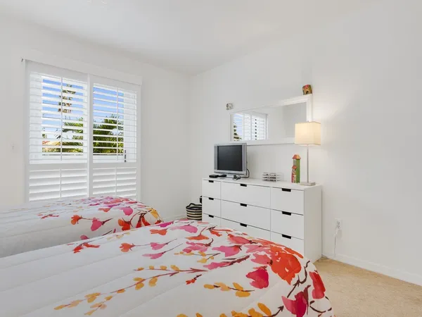 a bedroom with a bed and a dresser in it