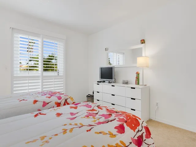 a bedroom with a bed and a dresser in it