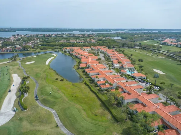 an aerial view of lake and residential houses with outdoor space
