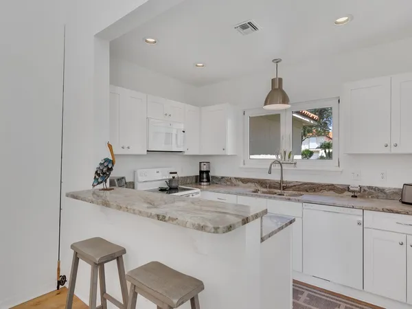 a kitchen with stainless steel appliances granite countertop a sink and cabinets