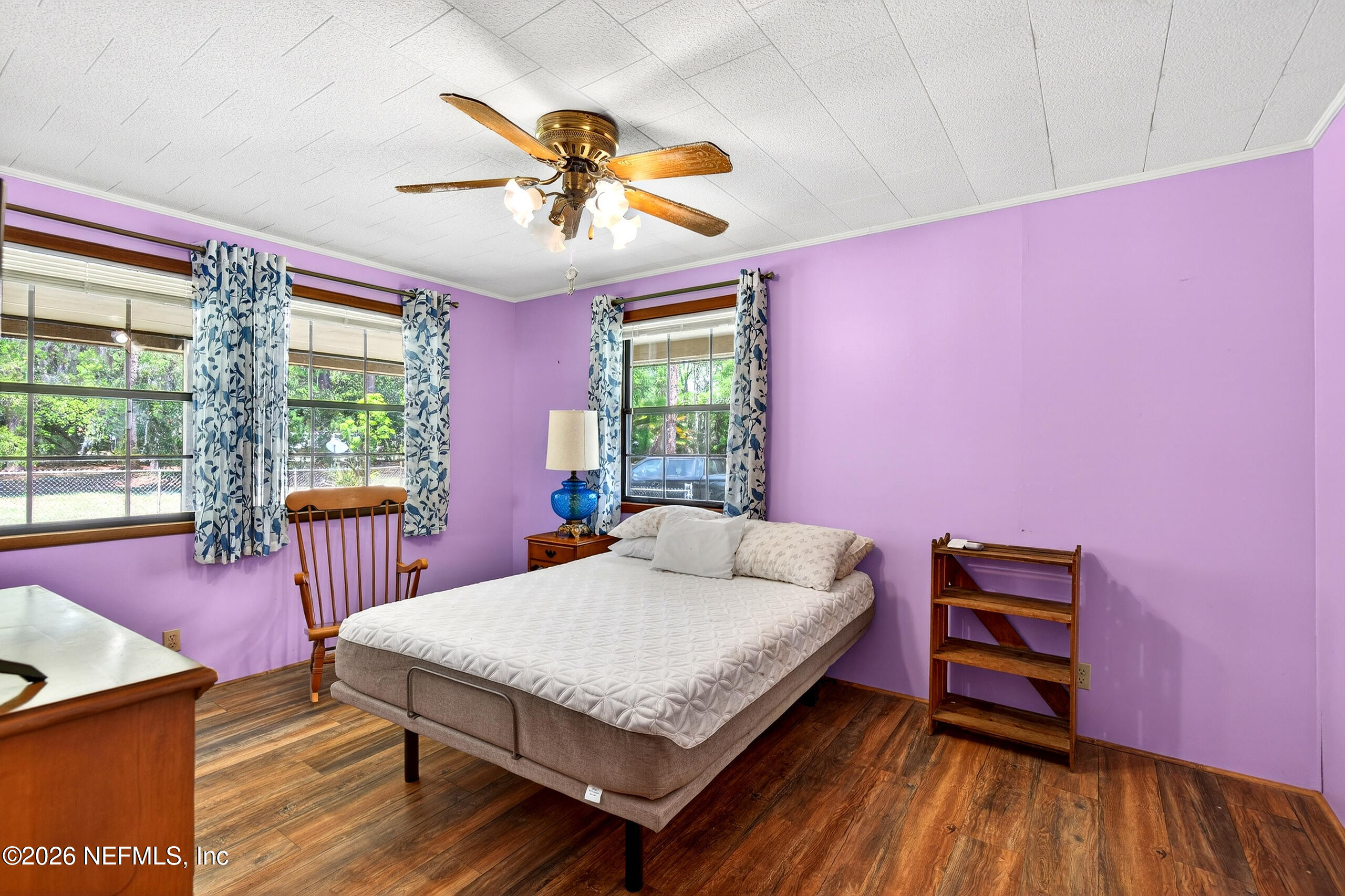 43122 Pineridge Drive Callahan, FL 32011 - Photo 13 of 46 a bedroom with a bed and a chandelier