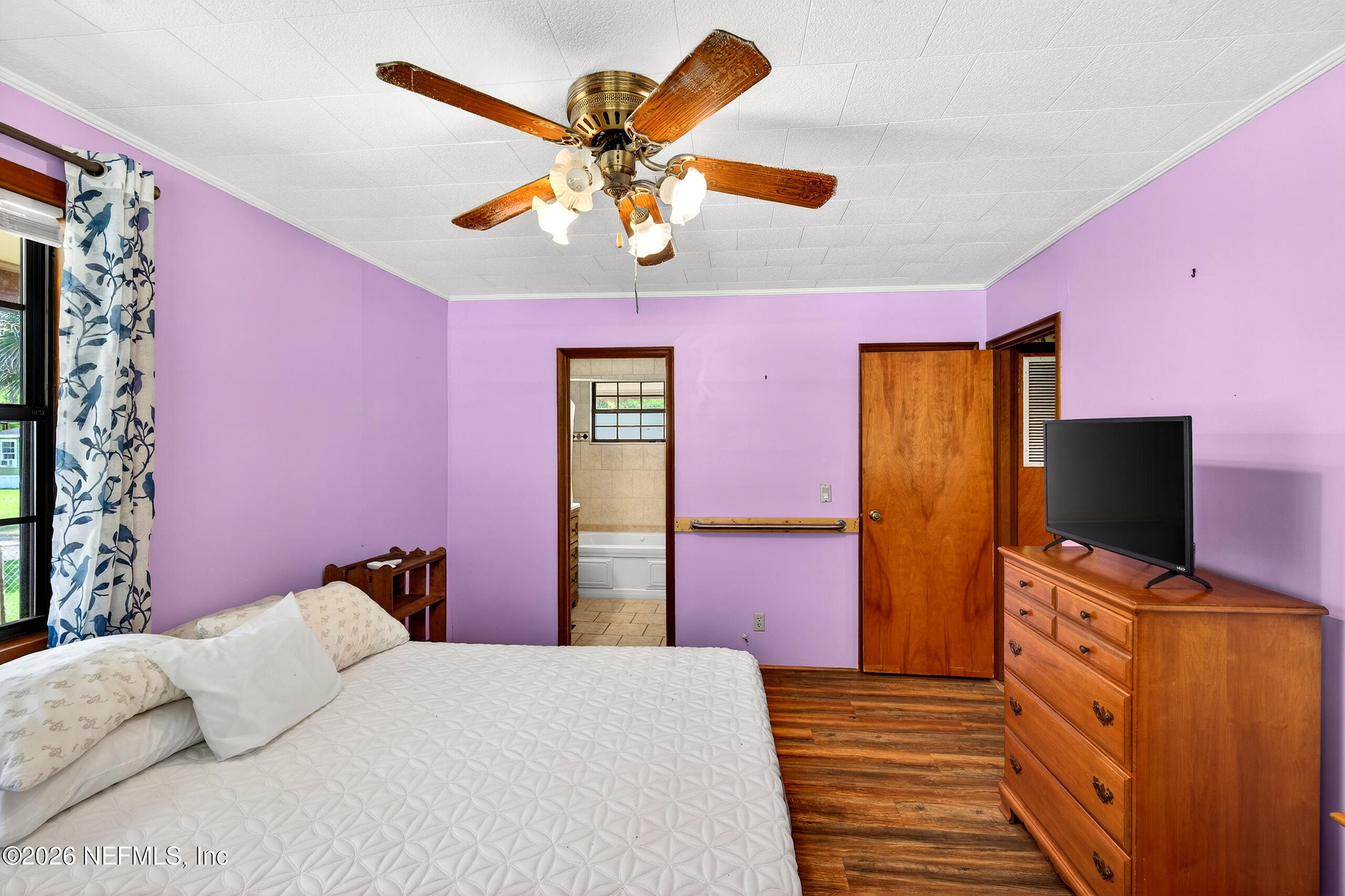 43122 Pineridge Drive Callahan, FL 32011 - Photo 14 of 46 a bedroom with a bed and a flat screen tv