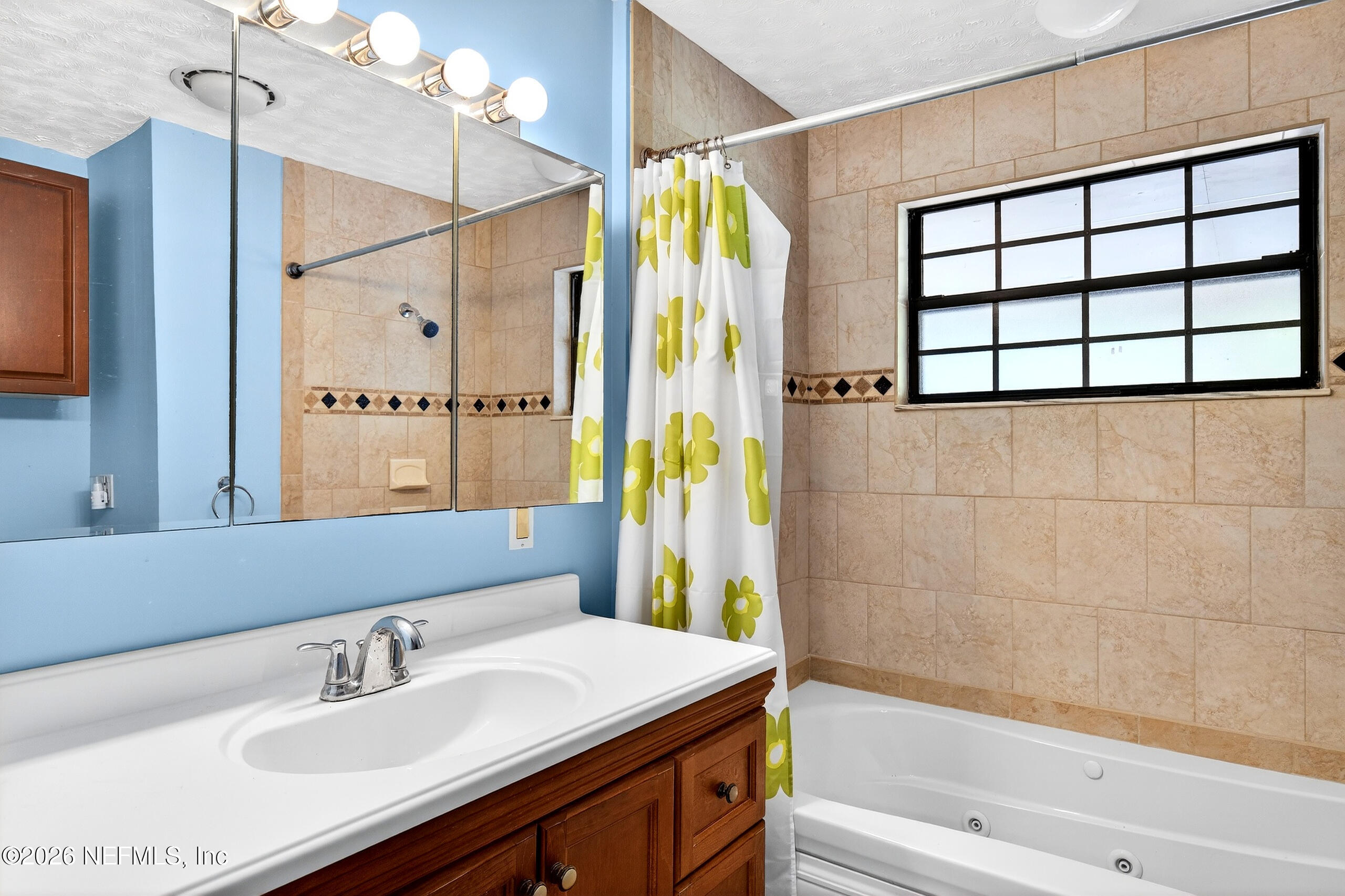 43122 Pineridge Drive Callahan, FL 32011 - Photo 15 of 46 a bathroom with a sink and a mirror