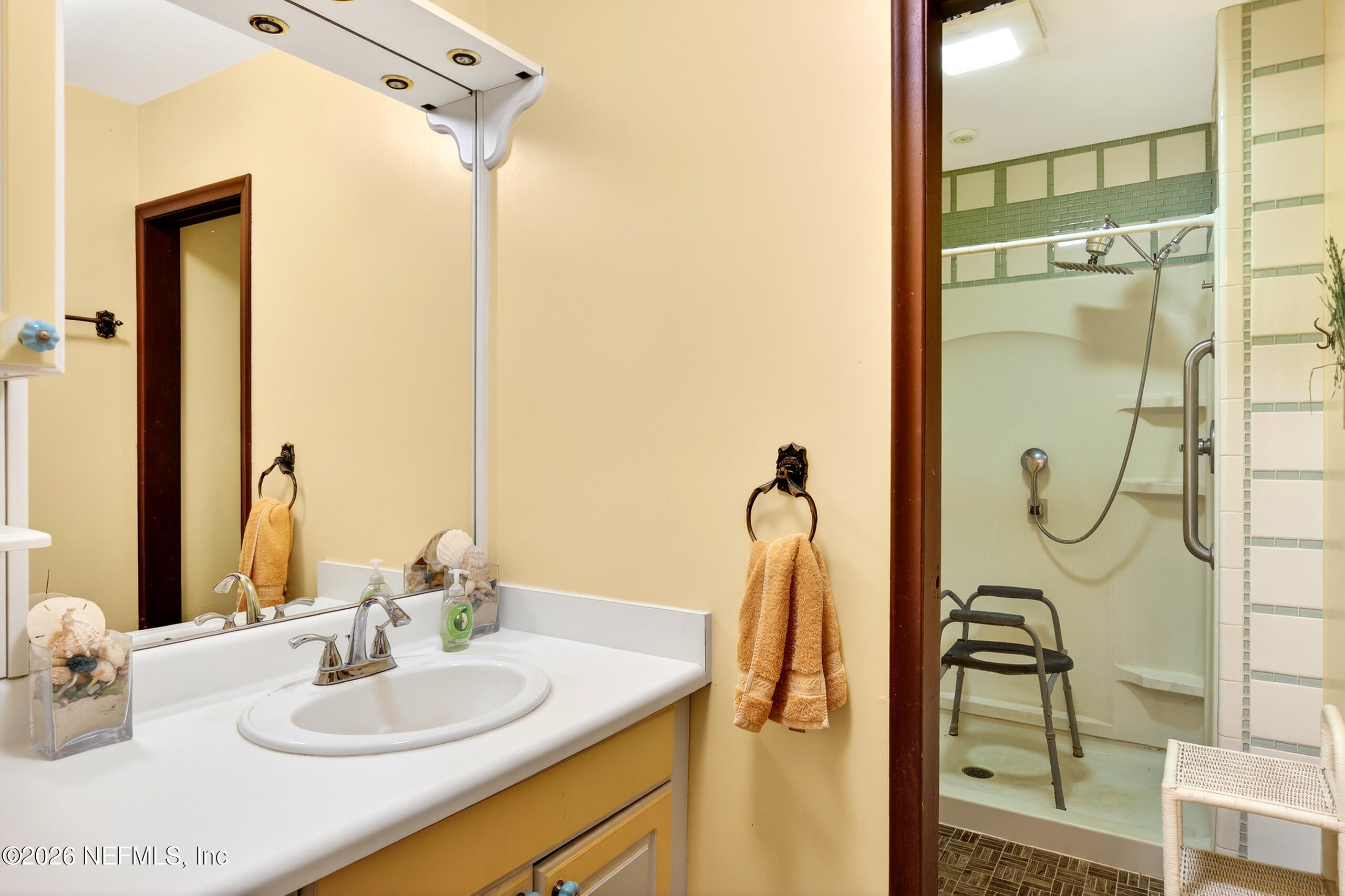 43122 Pineridge Drive Callahan, FL 32011 - Photo 18 of 46 a bathroom with a sink and a mirror
