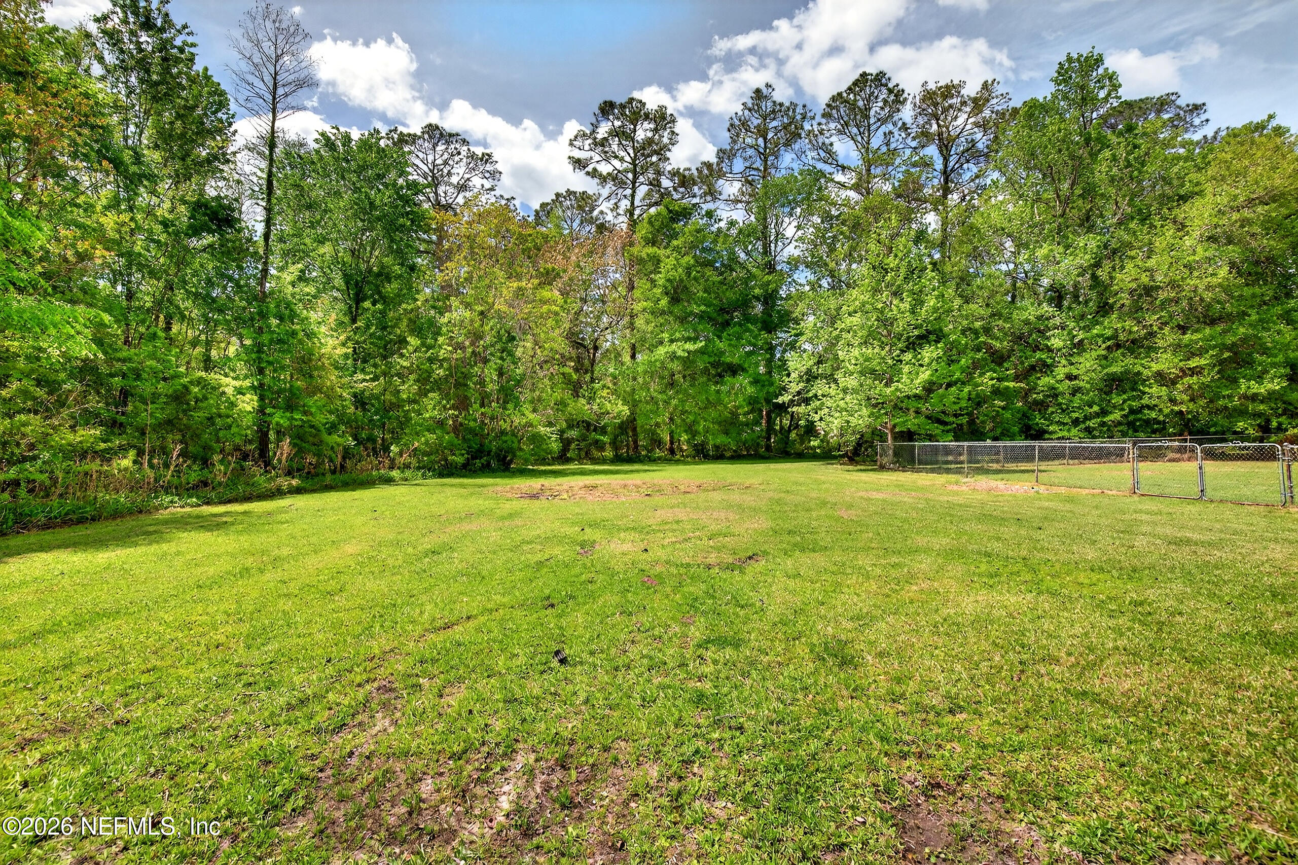 43122 Pineridge Drive Callahan, FL 32011 - Photo 27 of 46 a view of outdoor space with deck and yard