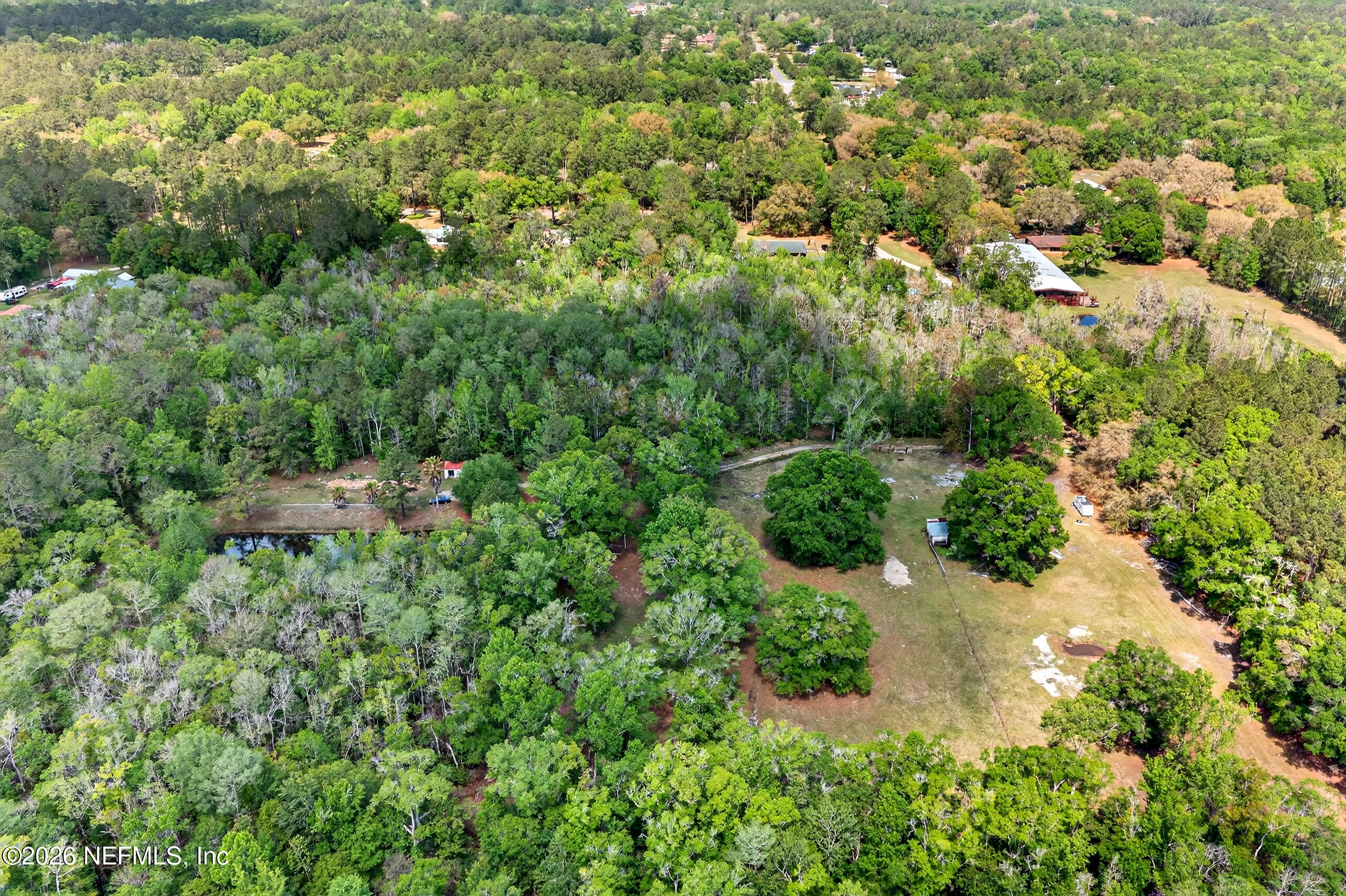 43122 Pineridge Drive Callahan, FL 32011 - Photo 36 of 46 an aerial view of residential house with outdoor space and trees all around