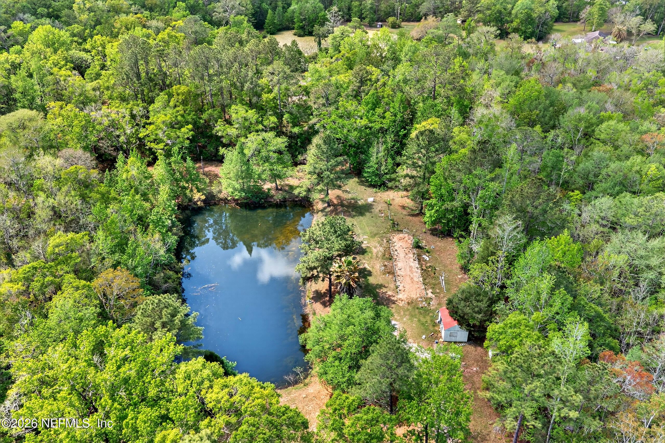 43122 Pineridge Drive Callahan, FL 32011 - Photo 42 of 46 an aerial view of a house with a yard and lake view