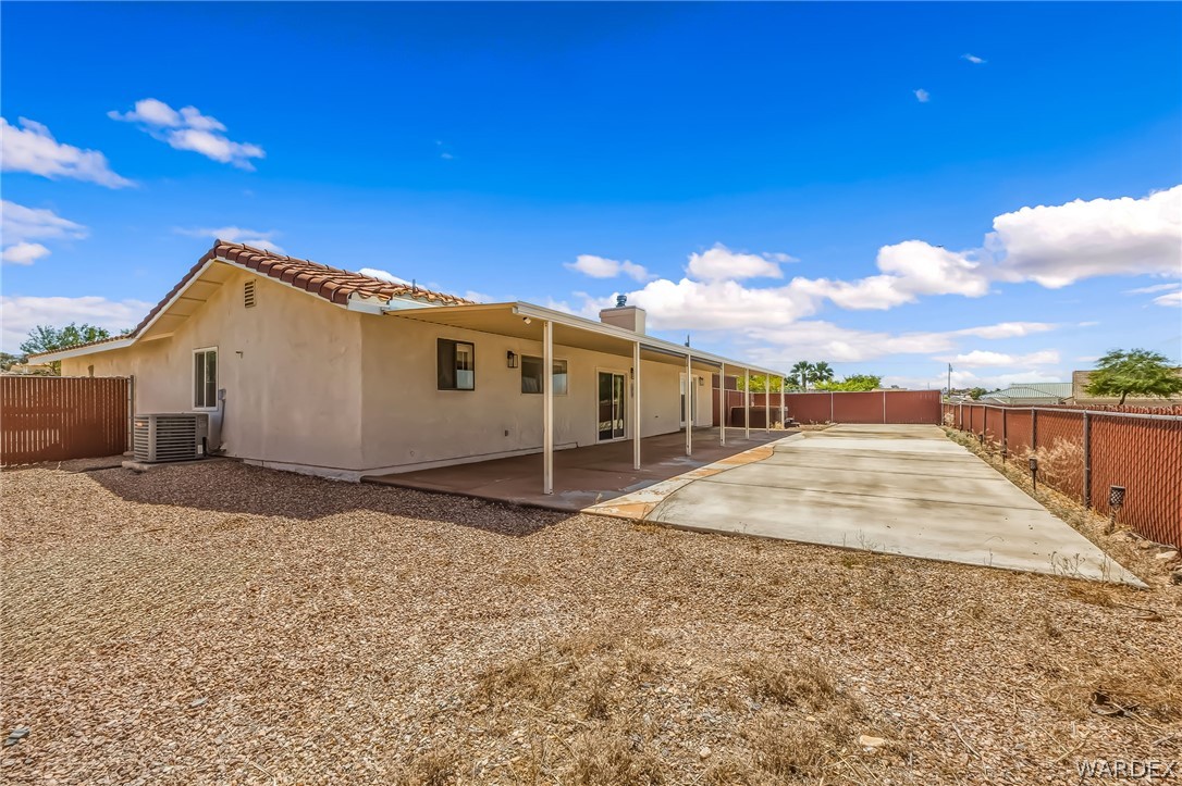 4088 Mercer Road Bullhead City, AZ 86429 - Photo 30 of 35 Rear exterior featuring a full-length covered patio, stucco siding, and a terracotta tile roof