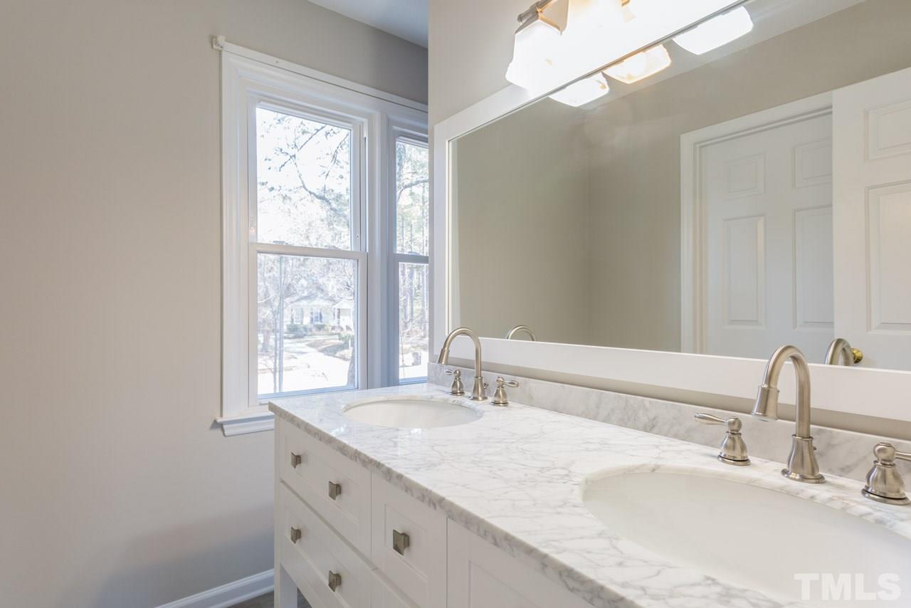 307 Winterberry Ridge Drive Durham, NC 27713 - Photo 11 of 19 a bathroom with a granite countertop sink and a large mirror
