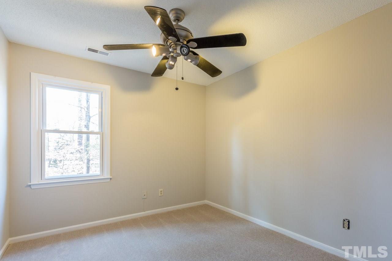 307 Winterberry Ridge Drive Durham, NC 27713 - Photo 14 of 19 an empty room with a window and a fan