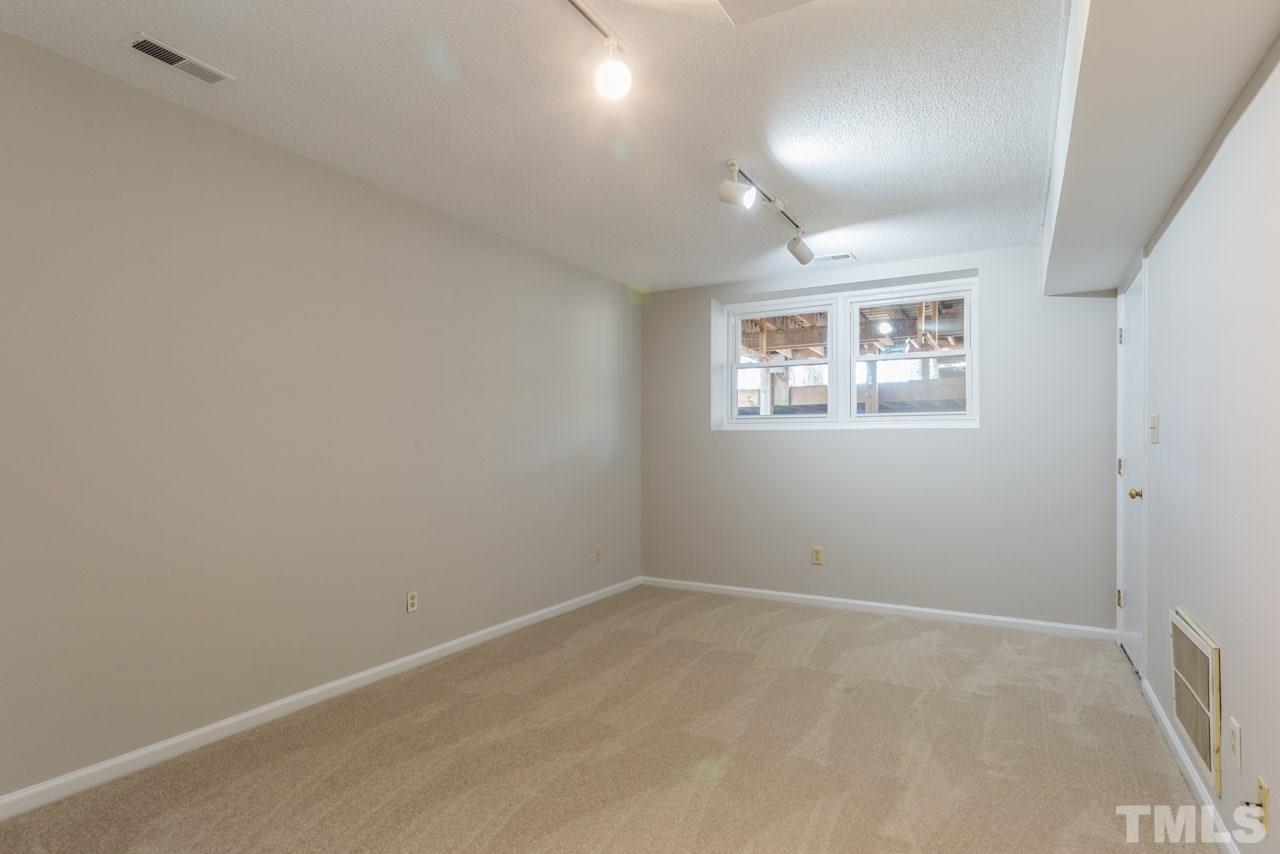 307 Winterberry Ridge Drive Durham, NC 27713 - Photo 16 of 19 an empty room with windows