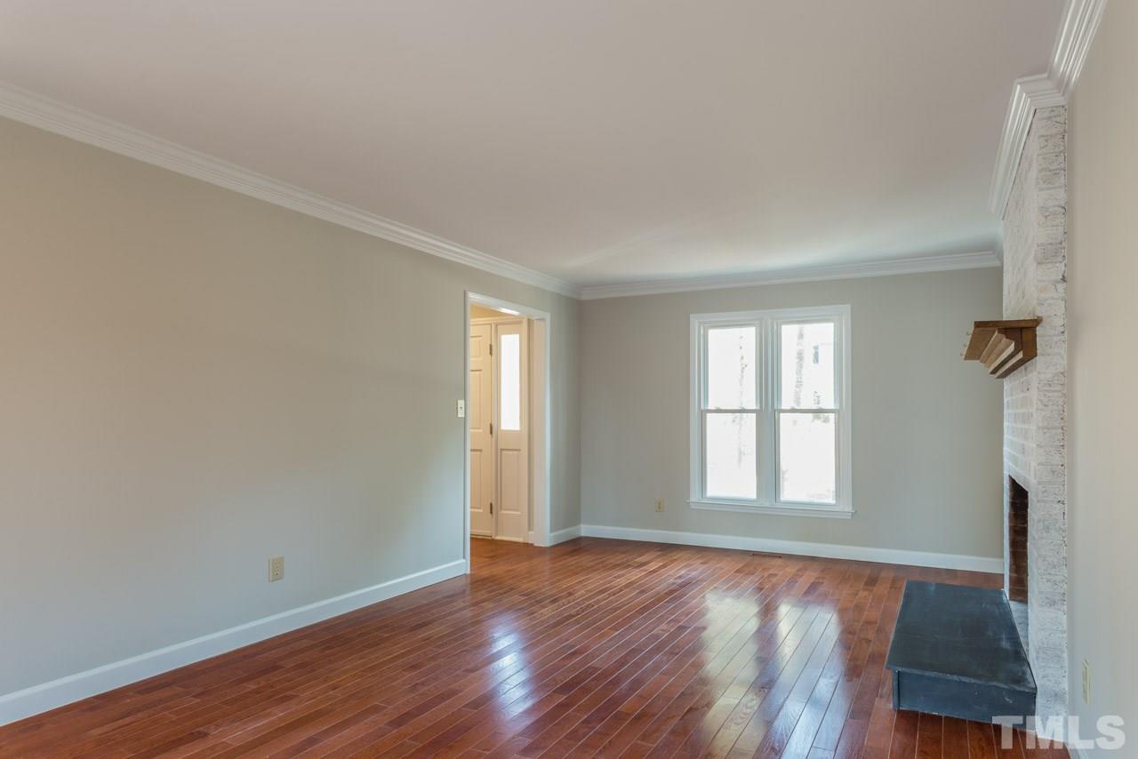 307 Winterberry Ridge Drive Durham, NC 27713 - Photo 4 of 19 an empty room with wooden floor and windows