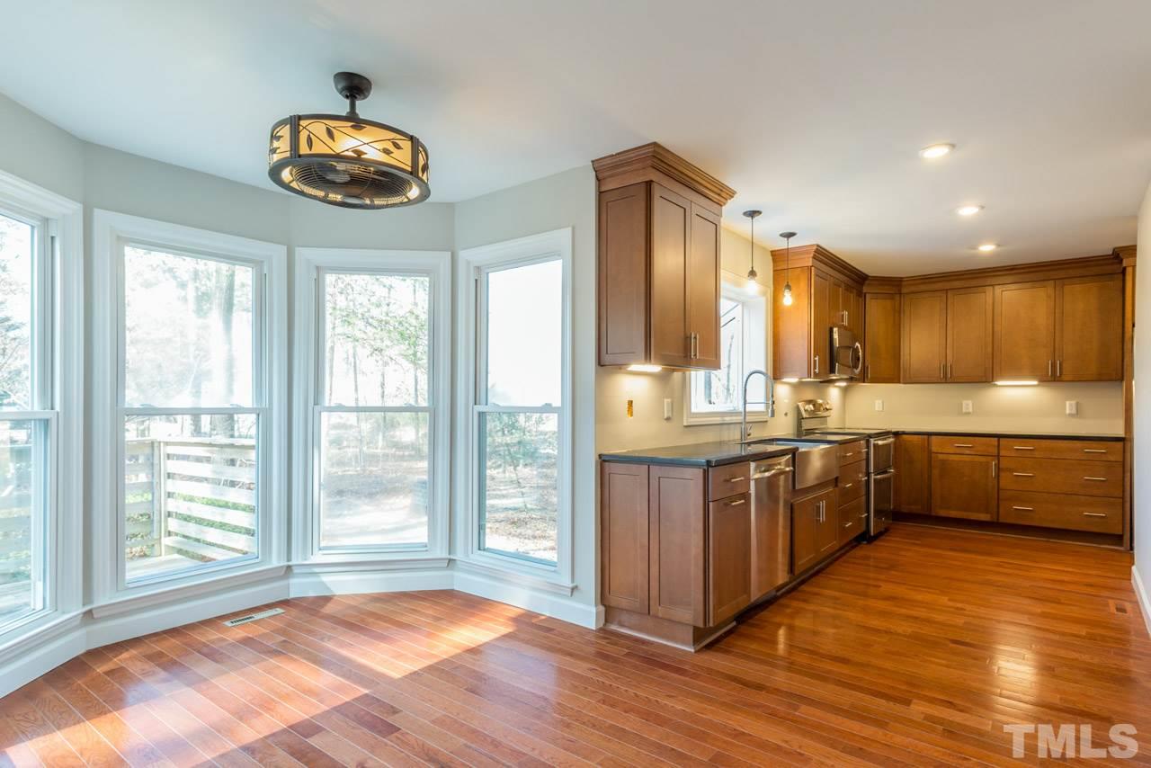 307 Winterberry Ridge Drive Durham, NC 27713 - Photo 5 of 19 a kitchen with stainless steel appliances granite countertop a stove a sink and a refrigerator