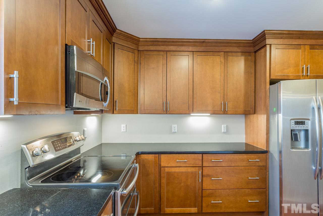 307 Winterberry Ridge Drive Durham, NC 27713 - Photo 7 of 19 a kitchen with stainless steel appliances granite countertop a sink a stove and a refrigerator