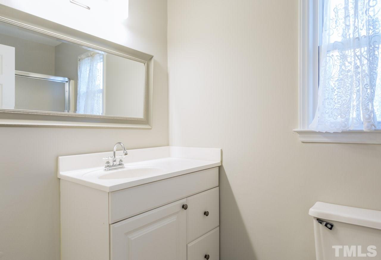 307 Winterberry Ridge Drive Durham, NC 27713 - Photo 8 of 19 a bathroom with a sink a vanity and a toilet