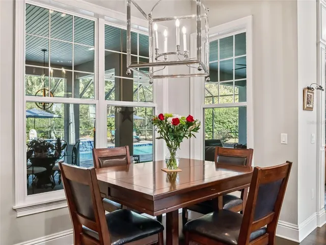 a bedroom with a large bed and a chandelier fan