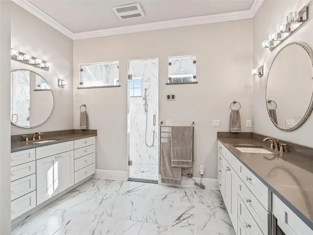 a bathroom with a granite countertop sink a toilet and shower