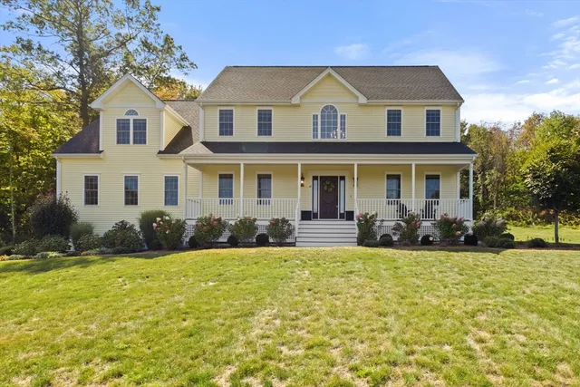 a front view of a house with swimming pool and garden