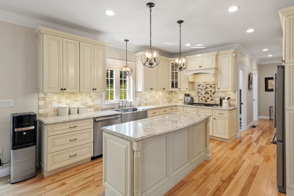 47 Fiske Mill Road Upton, MA 01568 - Photo 11 of 38 a large kitchen with kitchen island white cabinets and stainless steel appliances