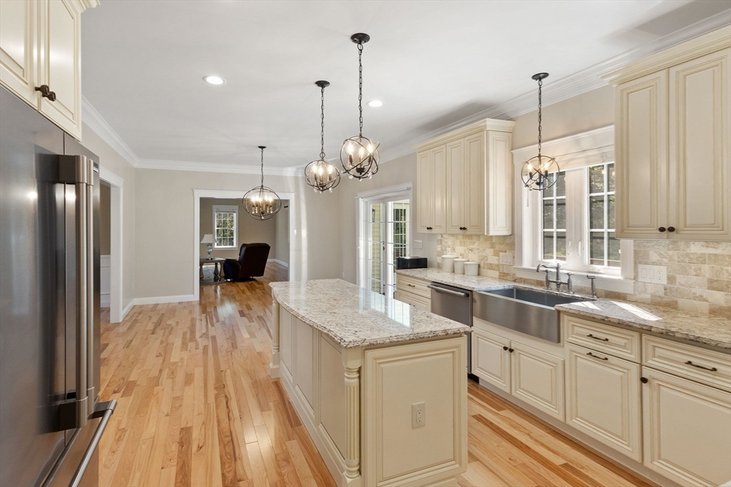 47 Fiske Mill Road Upton, MA 01568 - Photo 12 of 38 a large kitchen with kitchen island white cabinets and stainless steel appliances