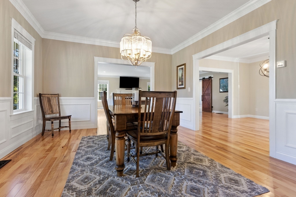 47 Fiske Mill Road Upton, MA 01568 - Photo 17 of 38 a view of a dining room with furniture a chandelier and wooden floor