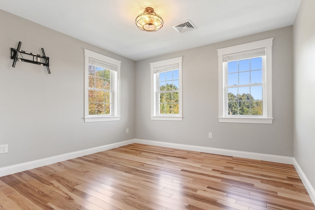 47 Fiske Mill Road Upton, MA 01568 - Photo 29 of 38 a view of empty room with wooden floor and window