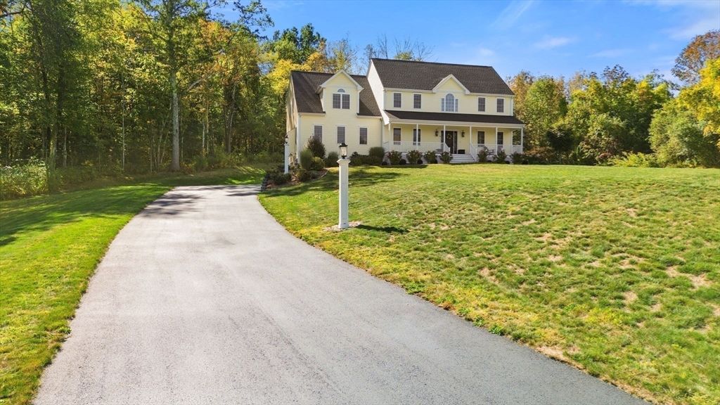 47 Fiske Mill Road Upton, MA 01568 - Photo 4 of 38 a view of a white house with a yard and potted plants