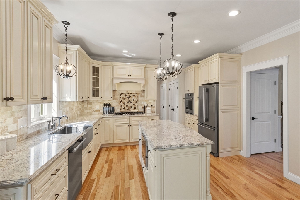 47 Fiske Mill Road Upton, MA 01568 - Photo 10 of 38 a large kitchen with granite countertop a large counter top a sink stainless steel appliances and cabinets