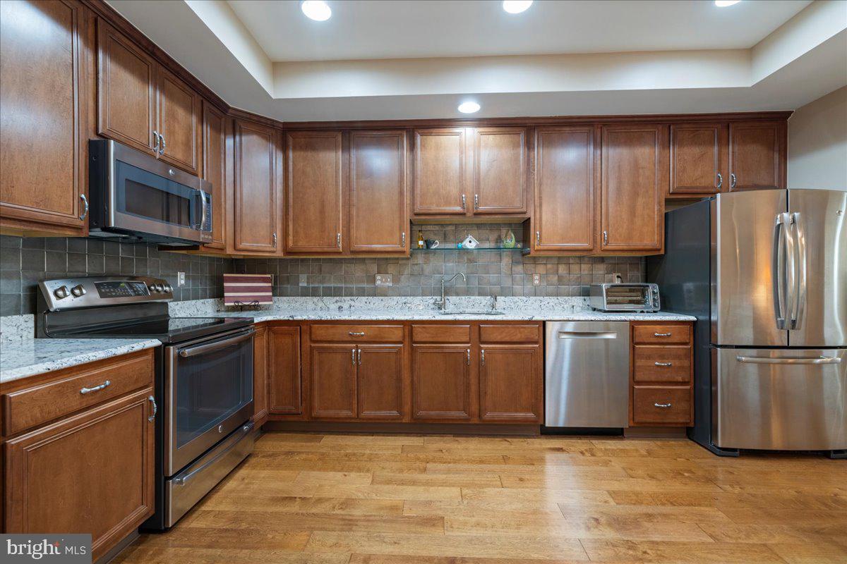 327 Melbourne Way Souderton, PA 18964 - Photo 11 of 44 a kitchen with stainless steel appliances granite countertop a refrigerator stove a sink and dishwasher