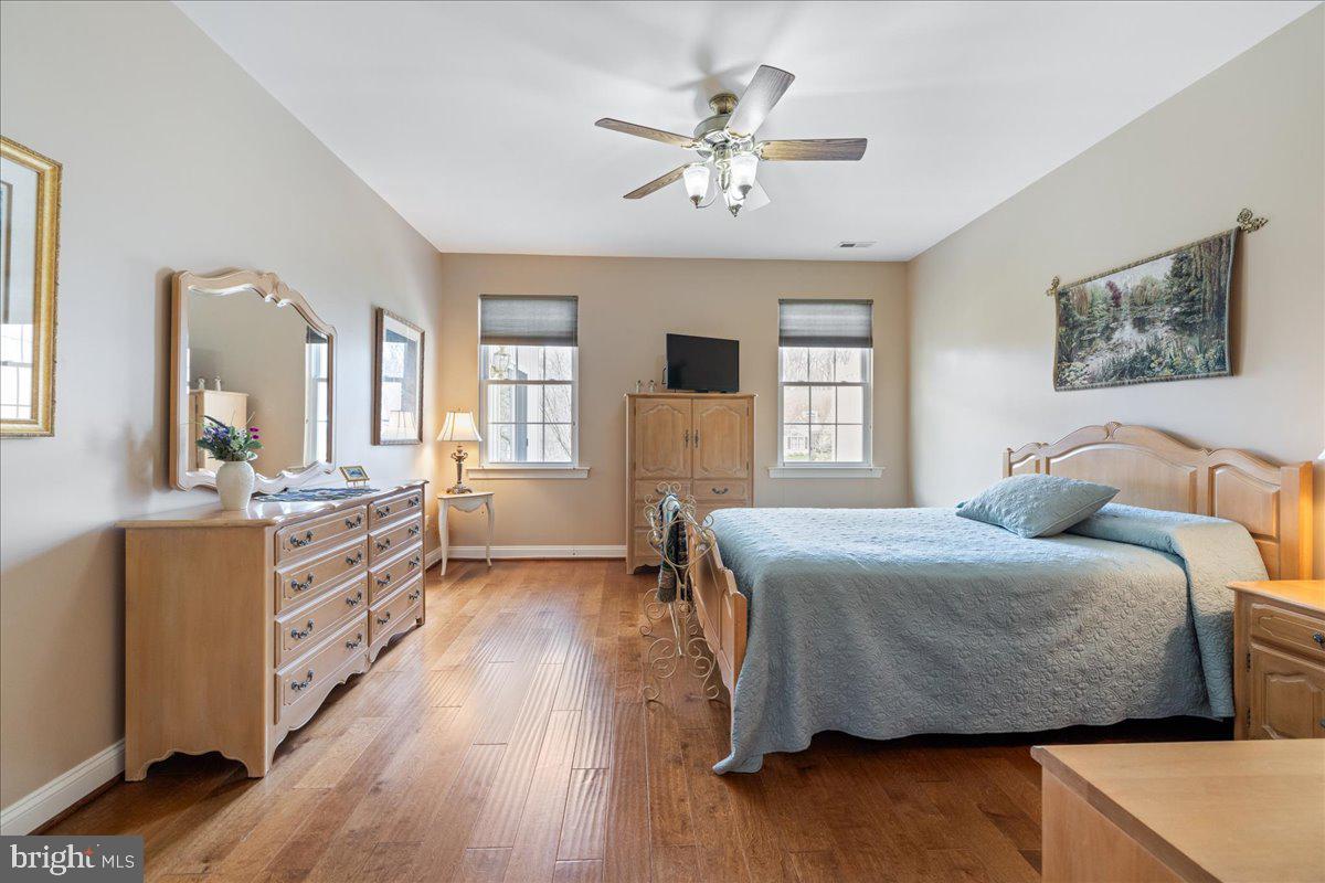 327 Melbourne Way Souderton, PA 18964 - Photo 18 of 44 a spacious bedroom with a bed a dresser and wooden floor