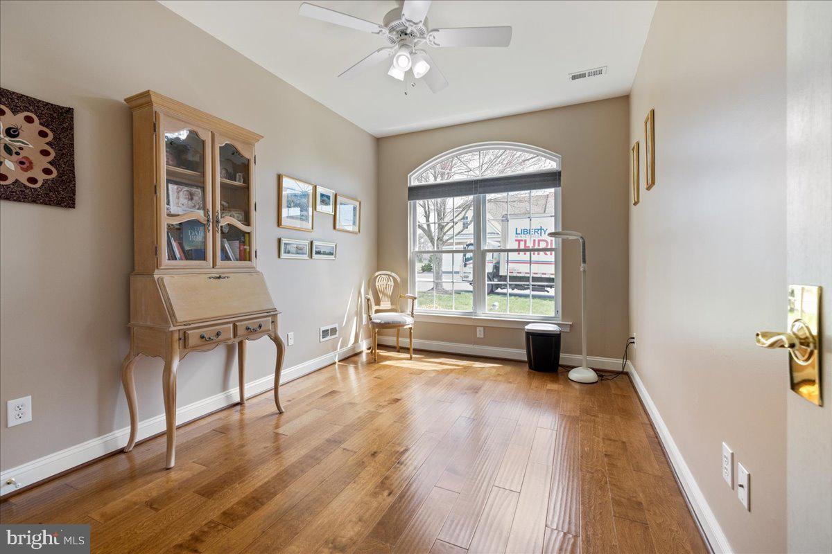327 Melbourne Way Souderton, PA 18964 - Photo 22 of 44 a view of an empty room with a window and wooden floor
