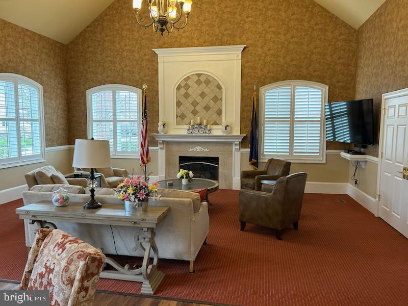 327 Melbourne Way Souderton, PA 18964 - Photo 38 of 44 a living room with furniture a fireplace and a flat screen tv