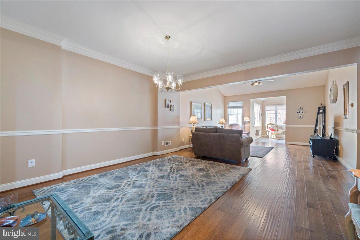 327 Melbourne Way Souderton, PA 18964 - Photo 7 of 44 a living room with furniture and a chandelier