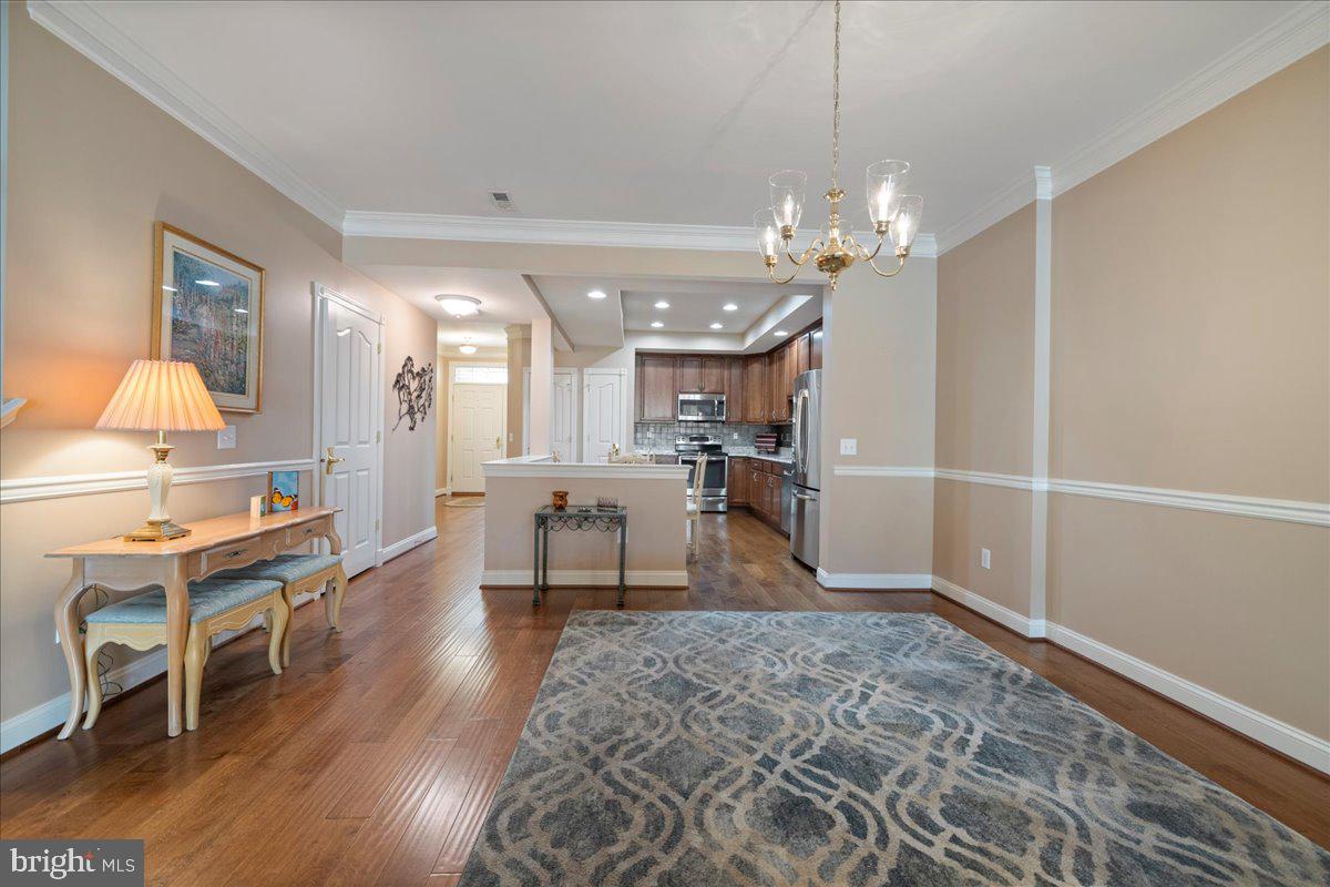 327 Melbourne Way Souderton, PA 18964 - Photo 8 of 44 a living room with furniture a dining table and a chandelier