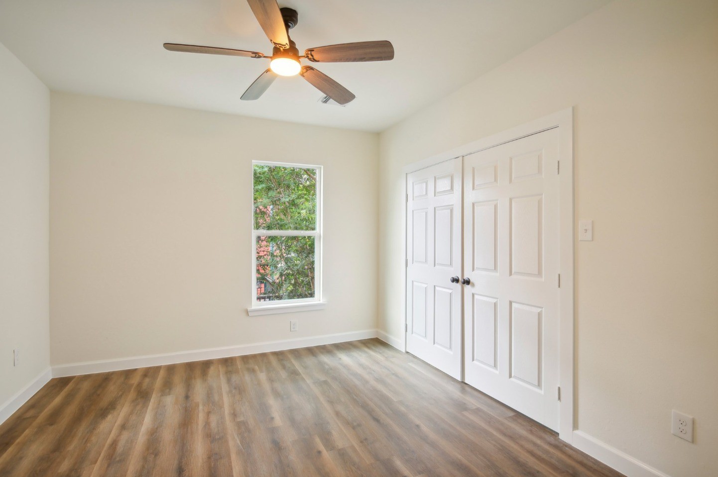 108 West 10th 1/2 Street Houston, TX 77008 - Photo 11 of 18 wooden floor in an empty room with a window
