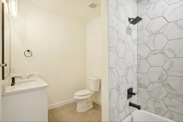 a white toilet sitting next to a white sink