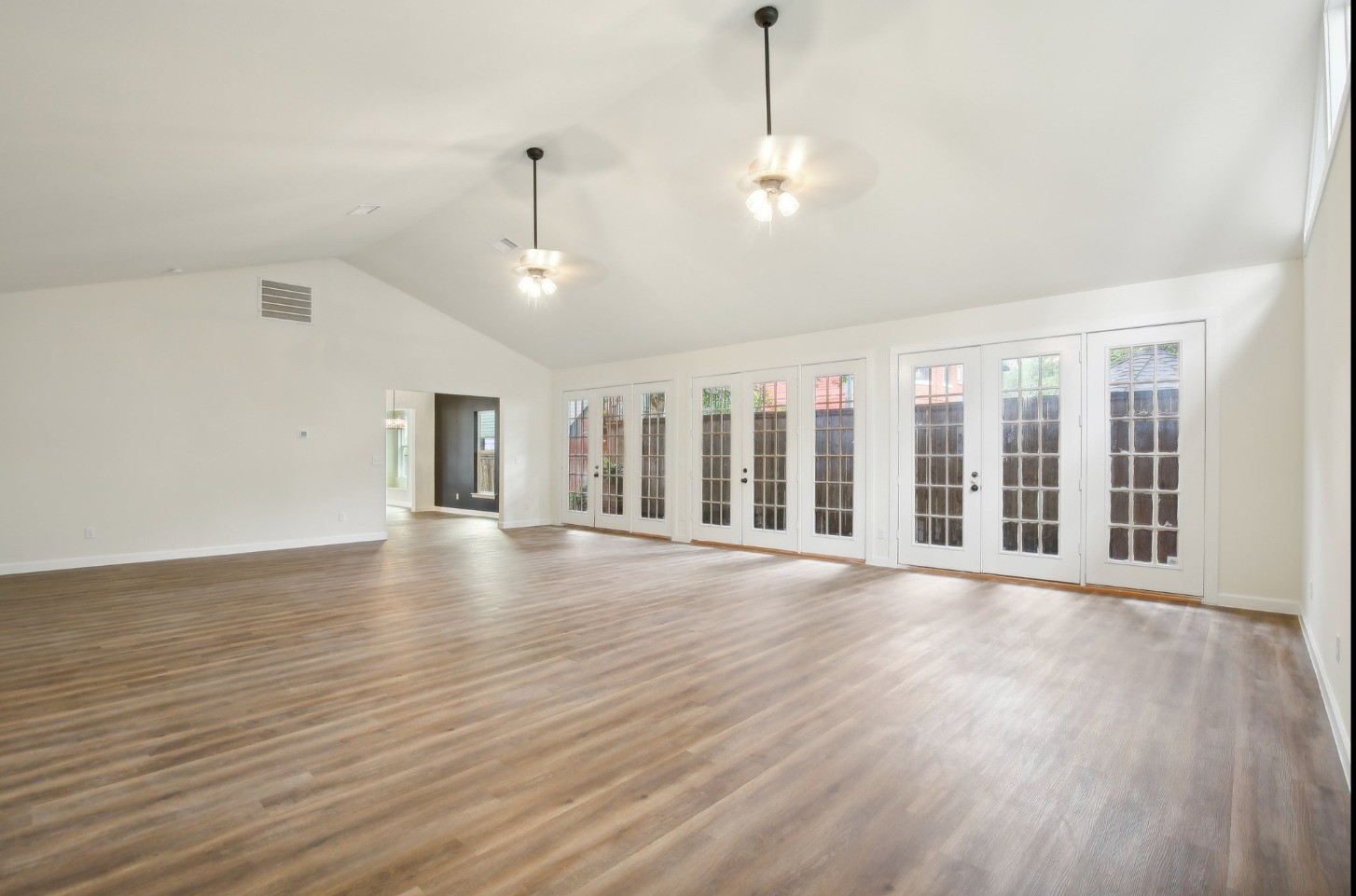 108 West 10th 1/2 Street Houston, TX 77008 - Photo 7 of 18 a view of an empty room with wooden floor and a window