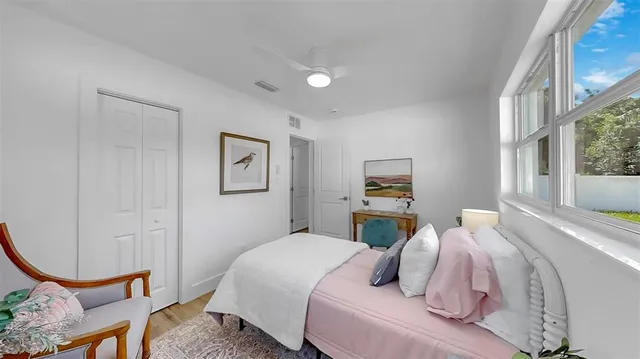 a bedroom with a bed and a window