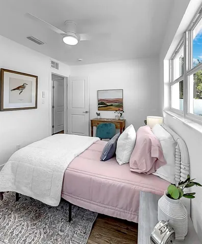 a bedroom with bed and a potted plant