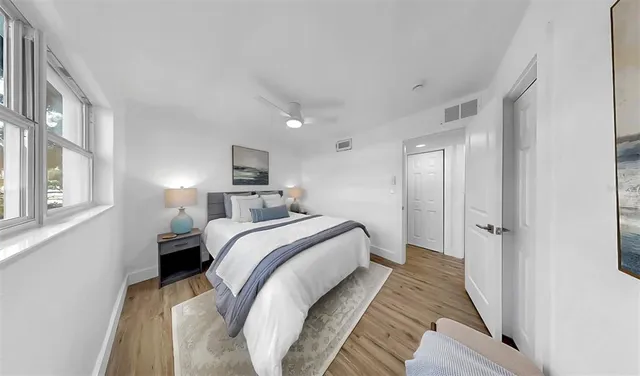 a bedroom with a bed and a mirror