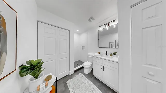 a bathroom with a sink a toilet and a mirror