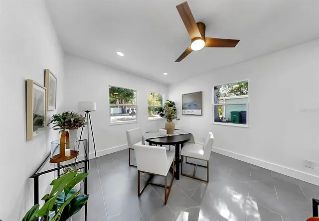 a work room with furniture and potted plants