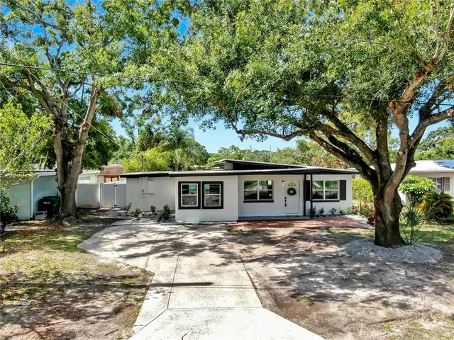 a front view of a house with yard patio and green space