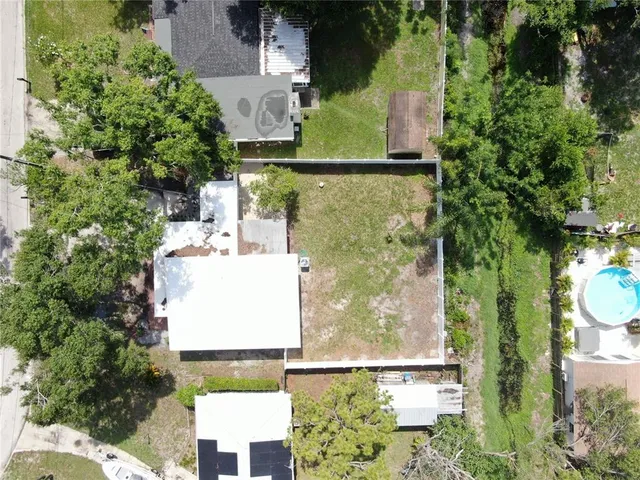 an aerial view of residential house with outdoor space and trees